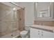 Bathroom with walk-in shower, white cabinets, and tiled countertop at 37 Stonemark Dr, Henderson, NV 89052