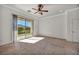 Bedroom with neutral carpet and a sliding glass door with a view of the backyard at 37 Stonemark Dr, Henderson, NV 89052