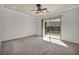 Cozy bedroom with a ceiling fan and sliding glass door leading to the backyard at 37 Stonemark Dr, Henderson, NV 89052