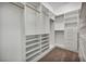 Walk-in closet with custom shelving and hanging rods at 37 Stonemark Dr, Henderson, NV 89052
