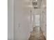 Hallway with tile flooring and white walls leads to various rooms, creating a seamless flow throughout the home at 37 Stonemark Dr, Henderson, NV 89052