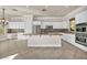 Well-lit kitchen featuring white cabinetry, stainless steel appliances, granite countertops, and tile flooring at 37 Stonemark Dr, Henderson, NV 89052