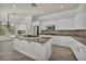 Bright kitchen featuring white cabinets, granite countertops, and stainless steel appliances at 37 Stonemark Dr, Henderson, NV 89052