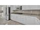 Close-up view of kitchen with white cabinetry, stainless steel appliances and granite countertops at 37 Stonemark Dr, Henderson, NV 89052