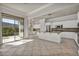 Expansive kitchen features white cabinets, granite countertops, and a seamless transition to outdoor living at 37 Stonemark Dr, Henderson, NV 89052