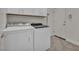 Bright laundry room with washer, dryer, storage, and tiled floor at 37 Stonemark Dr, Henderson, NV 89052
