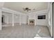 Spacious living area with fireplace, tile flooring, and plenty of natural light from large windows and sliding glass door at 37 Stonemark Dr, Henderson, NV 89052
