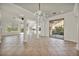 Bright living room boasts an ornate chandelier, tile floors, and sliding glass doors to the backyard at 37 Stonemark Dr, Henderson, NV 89052
