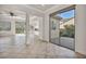 Bright living room with tile floors, recessed lighting, and sliding door access to the patio at 37 Stonemark Dr, Henderson, NV 89052