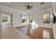 Bright living area with hardwood and tile flooring, large windows and glass sliding doors for outdoor access at 37 Stonemark Dr, Henderson, NV 89052