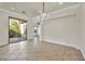 Open living area with tile floors, slider to back patio, and decorative chandelier lighting at 37 Stonemark Dr, Henderson, NV 89052
