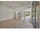 Open living space with tile flooring, chandelier lighting, columns, and sliding doors leading to the patio at 37 Stonemark Dr, Henderson, NV 89052