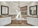 Luxurious bathroom with double sinks, soaking tub, and elegant fixtures at 37 Stonemark Dr, Henderson, NV 89052