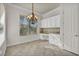 Office nook featuring a built-in desk, granite countertops, cabinets and chandelier lighting at 37 Stonemark Dr, Henderson, NV 89052