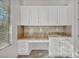 Desk area featuring built-in cabinets and granite countertops, illuminated by natural light at 37 Stonemark Dr, Henderson, NV 89052