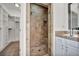 Tiled shower features a built-in bench and niche, with a frameless glass door at 37 Stonemark Dr, Henderson, NV 89052