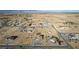 Sweeping aerial shows homes nestled within a desert community, complemented by a picturesque mountain range at 3821 Tumbleweed Ave, Pahrump, NV 89048