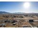 High-angle aerial of a desert neighborhood, highlighting homes and the vast mountain range beyond at 3821 Tumbleweed Ave, Pahrump, NV 89048