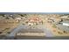 Aerial view of home with desert landscaping including circular driveway and view of surrounding community at 3821 Tumbleweed Ave, Pahrump, NV 89048