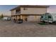 Backyard of the home featuring an RV, porch, and desert landscaping at 3821 Tumbleweed Ave, Pahrump, NV 89048
