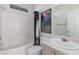 Bright bathroom with a shower-tub combination, single sink vanity, and a themed shower curtain at 3821 Tumbleweed Ave, Pahrump, NV 89048