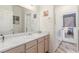 Bathroom featuring wood floors, single sink vanity, and access to a laundry area at 3821 Tumbleweed Ave, Pahrump, NV 89048