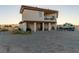 Two-story home with a balcony, covered patio, and lots of land to make this property your own at 3821 Tumbleweed Ave, Pahrump, NV 89048