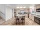 Well-lit kitchen featuring an island, barstool seating, and modern appliances at 3821 Tumbleweed Ave, Pahrump, NV 89048