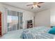 Bright bedroom with sliding glass doors to balcony and a television at 3821 Tumbleweed Ave, Pahrump, NV 89048