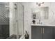Modern bathroom features luxurious tiled walk-in shower and patterned gray vanity at 3826 Edmond St, Las Vegas, NV 89103