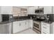 Close up on a modern kitchen featuring stainless steel appliances and sleek black backsplash at 3826 Edmond St, Las Vegas, NV 89103