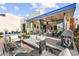 An elegant backyard featuring a fire pit, outdoor seating, and a covered patio for ultimate relaxation and entertainment at 387 Solitude Peak Ln, Henderson, NV 89012