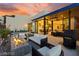 Beautiful backyard with a fire pit, outdoor seating, and a covered patio offering serene relaxation and entertainment at 387 Solitude Peak Ln, Henderson, NV 89012