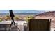 Relaxing balcony view with a telescope pointed toward the city skyline in the distance at 387 Solitude Peak Ln, Henderson, NV 89012