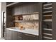 Wet bar area with sleek countertops and wine refrigerator at 387 Solitude Peak Ln, Henderson, NV 89012