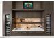 Modern bar area features sleek cabinetry, wine coolers, beverage storage and stylish countertop at 387 Solitude Peak Ln, Henderson, NV 89012
