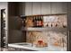 Wet bar area with sleek countertops, glassware, and wine refrigerator at 387 Solitude Peak Ln, Henderson, NV 89012