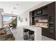 Entertainer's dream with a bar area, seating, and seamless flow to dining space with mountain views at 387 Solitude Peak Ln, Henderson, NV 89012