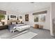 Bright bedroom features soft carpet, large windows, and neutral-toned decor providing a serene atmosphere at 387 Solitude Peak Ln, Henderson, NV 89012