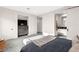 Bright bedroom features soft carpet, ensuite bathroom with sliding door, and a large flat screen TV at 387 Solitude Peak Ln, Henderson, NV 89012