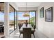 Elegant dining room with a wood table, chandelier and sliding glass doors to an outdoor view at 387 Solitude Peak Ln, Henderson, NV 89012