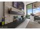 Modern fireplace design with stone surround and sleek, black mantle at 387 Solitude Peak Ln, Henderson, NV 89012