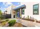 Modern home with a vibrant blue door, desert landscaping, and a stylish entrance, creating an inviting curb appeal at 387 Solitude Peak Ln, Henderson, NV 89012