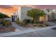 Contemporary home exterior with modern landscaping, a blue front door and a garage at 387 Solitude Peak Ln, Henderson, NV 89012