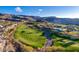 Breathtaking aerial shot captures a luxurious golf course community with stunning homes and picturesque mountain views at 387 Solitude Peak Ln, Henderson, NV 89012