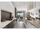 Modern kitchen with cooktop island and living area at 387 Solitude Peak Ln, Henderson, NV 89012