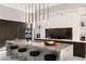 Gourmet kitchen featuring a large island with counter seating and designer pendant lighting at 387 Solitude Peak Ln, Henderson, NV 89012