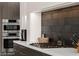 Modern kitchen with built in stainless steel oven and sleek cooktop at 387 Solitude Peak Ln, Henderson, NV 89012