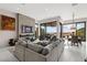 Spacious living room features an elegant fireplace and a wall of sliding glass doors at 387 Solitude Peak Ln, Henderson, NV 89012