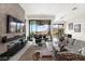 Cozy living room has an eye-catching fireplace and a wall of sliding glass doors at 387 Solitude Peak Ln, Henderson, NV 89012